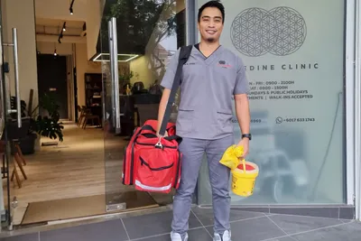 Dr Wan Afdzal heading out on a housecall with his home-visit kit