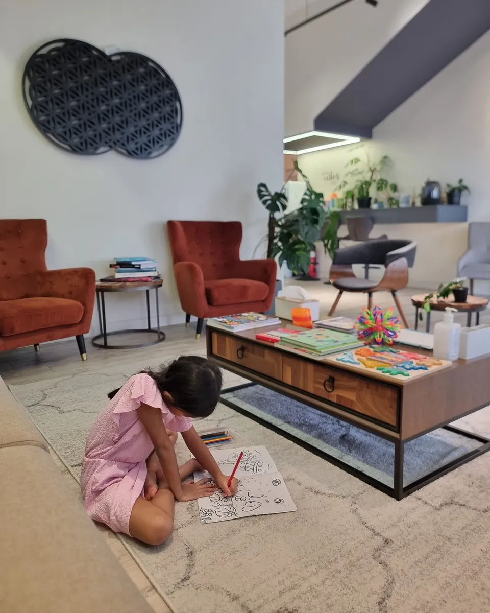 A young visitor colouring at the kids' corner in the Remedine Clinic lounge