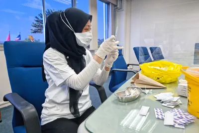 A nurse preparing a travel vaccine