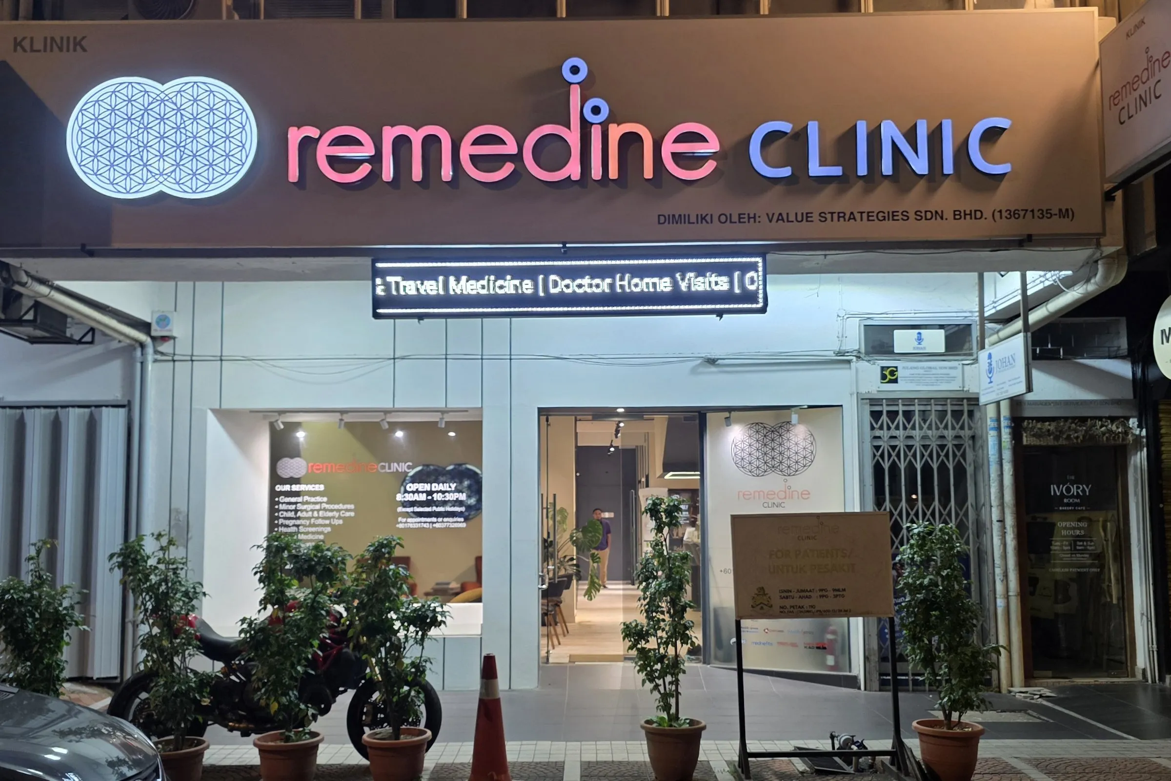 Remedine Clinic TTDI storefront lit at night on Persiaran Zaaba, full signboard and entrance